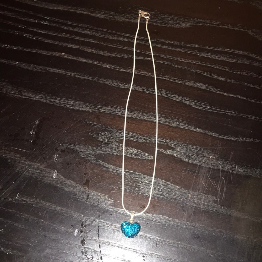 a heart necklace with jewels